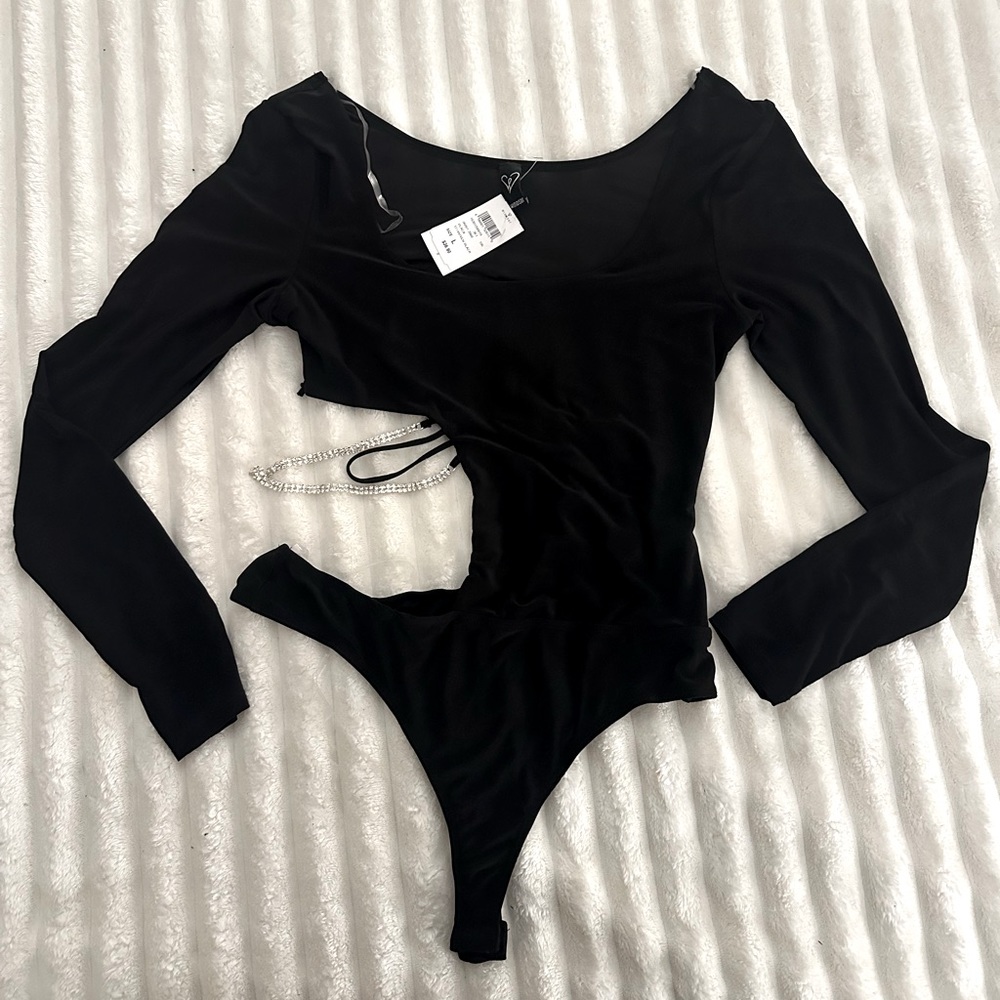 Black body suit. Rhinestone cut out side